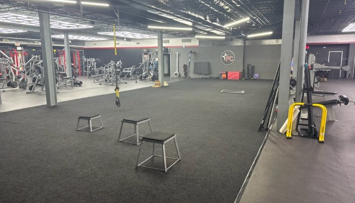 The main floor of our fitness and wellness gym with black turf